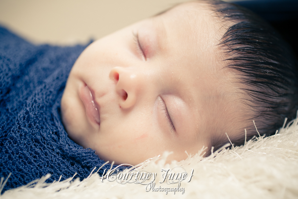 newborn photographer photographing a close up of a newborn baby's eyelashes 